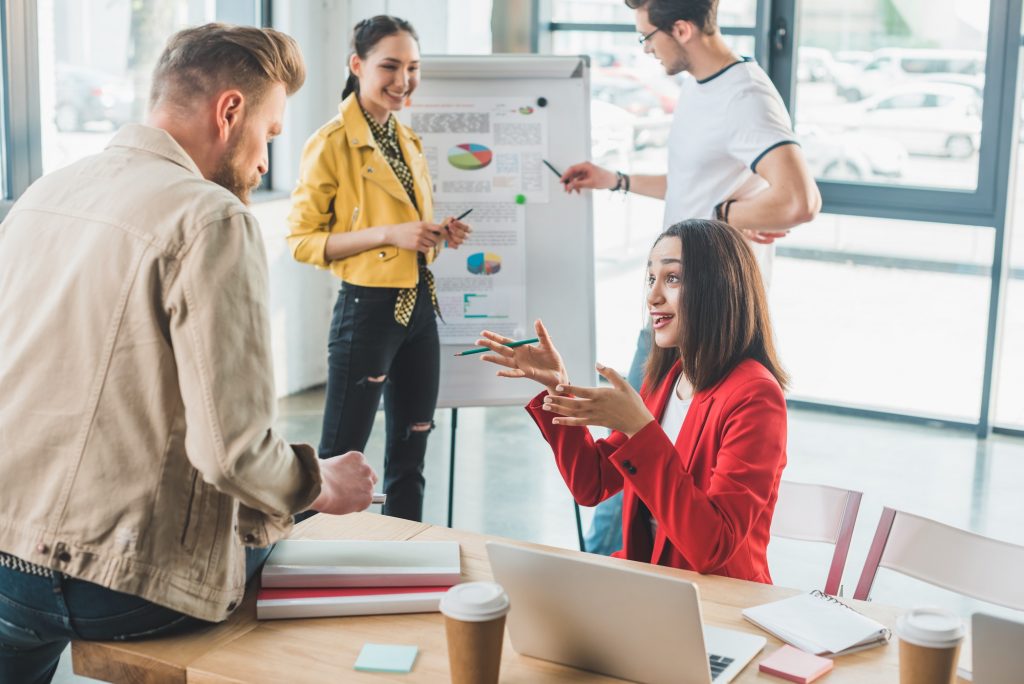 Professional colleagues discussing business results in modern office