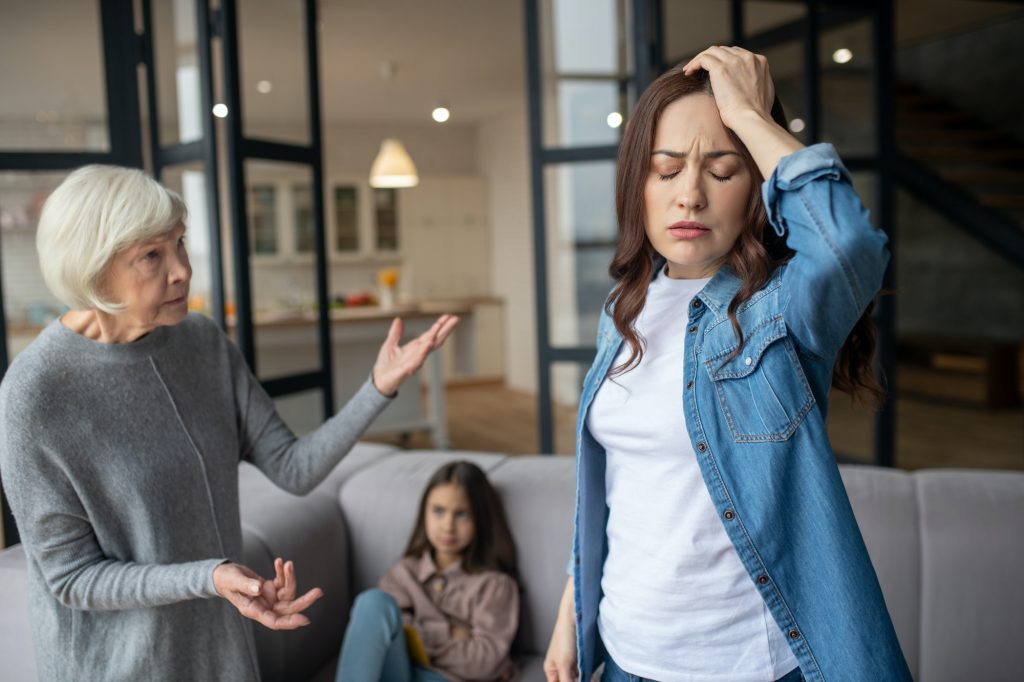 Adult daughter and mom argue while talking.