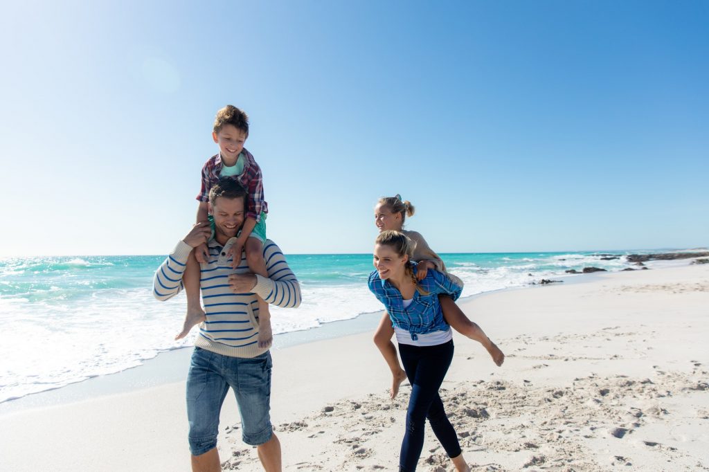 Parents and children having fun at the beach